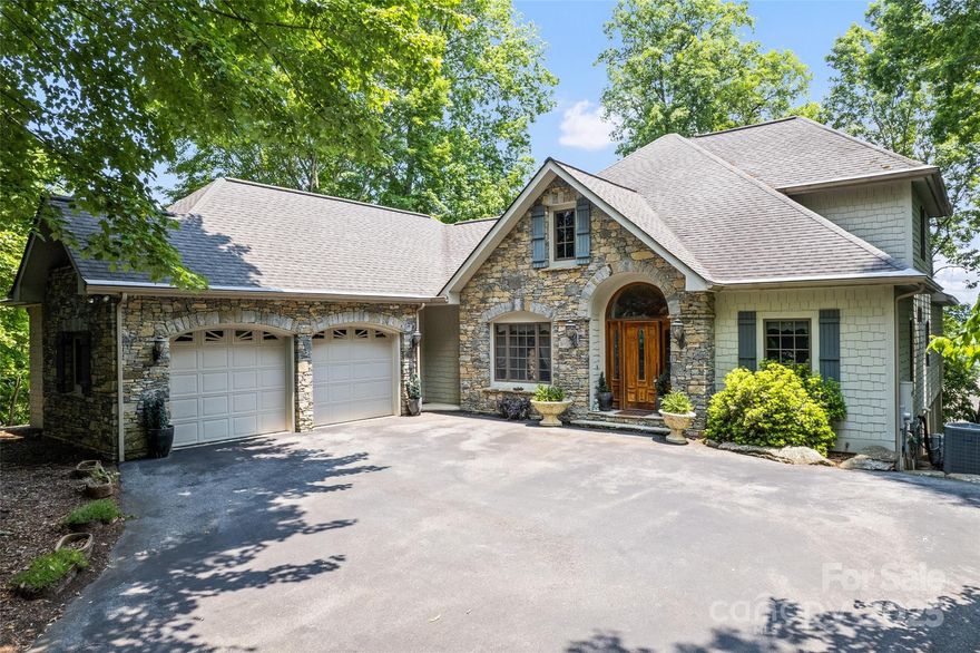 ***UPDATE: THE VIEW HAS BEEN OPENED AND IT IS BREATHTAKING!*** This exquisite luxury residence offers an unparalleled mountain living experience. Step inside a grand entryway with vaulted ceilings. The main level primary ensuite bedroom offers a gas log fireplace and dual closets. A lovely staircase leads to a large en-suite bedroom. The gourmet kitchen is a chef's delight with high-end wood cabinetry, granite countertops, and is open to the great room with an eat-in area. The immaculate 2-car garage features durable outdoor carpet. The finished walkout basement features a second living room with a wet bar and gas log fireplace, another primary ensuite bedroom, and an exquisite, spa-like bathroom. The basement also offers an additional 1,376 square feet of unfinished space for expansion potential. Enjoy the tranquility and natural beauty of Maggie Valley from two covered decks and a screened porch. Modern amenities include a tankless hot water heater, Beam Serenity Plus Water Filtration System, and an ADT Security System.