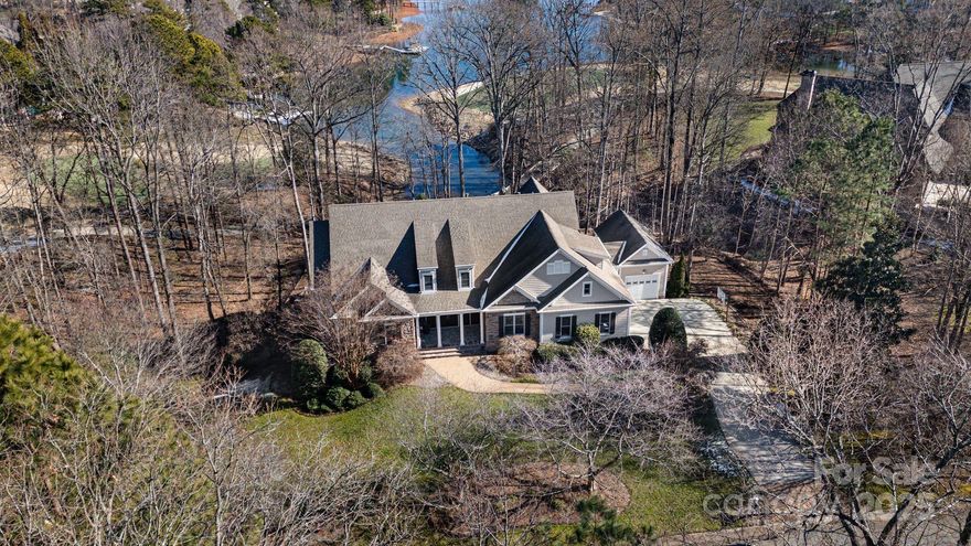 Delight in 1.32 acres in the Point community! Offering lake and golf course views, complete with a deeded boat slip, and an elevator. Step through stunning wood and glass doors into a 2-story foyer that flows to a seamlessly connecting the kitchen, great room, and breakfast area. The kitchen boasts a built-in Sub-Zero refrigerator, double ovens, a gas range, a walk-in pantry, and a butler’s pantry. The main-level owner’s suite offers a cozy fireplace, a spacious walk-in closet, a spa-inspired shower, a beverage fridge, and a private laundry. Upstairs, find 3 bedrooms, 2 full baths, a craft/flex room, and loft space. The finished walk-out basement features 2nd living quarters, complete with a full kitchen, family room, office, and bonus room, providing ample space for guests. Laundry rooms on each floor for ultimate convenience. Unwind in the resurfaced Pebble Tec saltwater pool, set within a fully fenced backyard, plus waterfront for easy paddle board and kayak access.