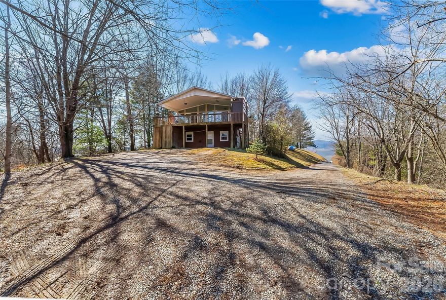 Nestled on 6.16 private acres in a tranquil setting with stunning long-range mountain views, this 3-bedroom, 2.5-bath home offers the perfect blend of privacy and convenience, just approximately 10 minutes from downtown Marshall.

The bright and airy open floor plan seamlessly connects the living, dining, and kitchen areas, creating an inviting space ideal for everyday living and entertaining. The living and dining areas feature beautiful built-ins that provide added character and functional storage. The kitchen touts a breakfast bar, stainless steel appliances, and ample cabinetry.

Enjoy the mountain views from the spacious covered deck, perfect for relaxing or hosting gatherings. The large backyard offers plenty of room for pets, gardening, or outdoor activities. A ceiling fan in the living area keeps things comfortable year-round, and the whole-house generator ensures you never have to worry about power outages.

The basement provides additional flexibility with a bedroom and bathroom, suitable for guests, a home office, or extended living space. An outbuilding with its own bedroom and bathroom offers endless possibilities—perfect for a workshop, studio, or potential income-producing opportunity. A separate storage shed and a 3-car garage provide abundant space for vehicles, tools, and hobbies.

Fiber optic internet service is available, offering fast and reliable connectivity for work or entertainment.

Conveniently located near shopping, dining, and local amenities, this property combines peaceful surroundings with easy access to town. A unique opportunity with endless potential. Make it yours today!