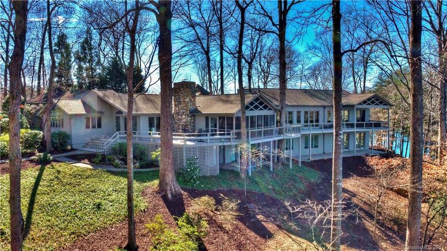 This redesigned waterfront home merges casual elegance with sweeping Lake Norman views from wide spanning decks & porches. 2007 West Wing addition doubling the home boasts high-end finishes of Brazillian cherry hardwoods, Travertine, 2nd kitchen, 2nd master, study & lower level billiards. Remodeled primary home offers separate entry, new master & guest baths. Private pier has boathouse w/lift. Fantastic location near shops & dining, 25 mi to Charlotte/airport. Option to purch adj 0.7 acre lot.