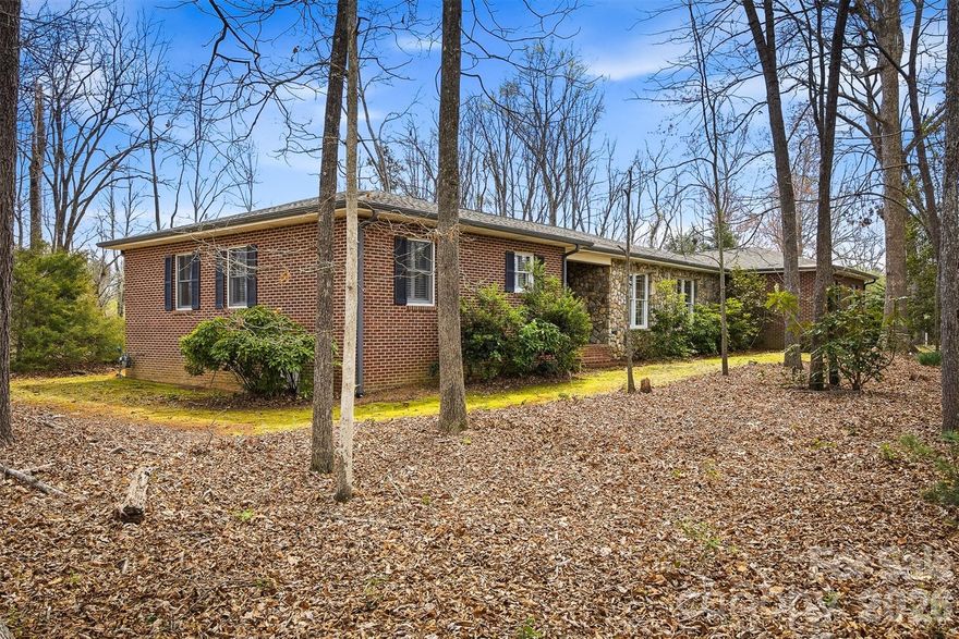 Welcome to this brick and stone home offering easy one-level living in the desirable Heritage Park Subdivision of Morganton, NC. Built in 1979 and lovingly cared for by its original owner, this 3-bedroom, 2-bath residence sits on a spacious 1.02-acre lot. Inside, you’ll find an inviting eat-in kitchen featuring an island and granite countertops, a dining room, and two comfortable living areas—one with a cozy wood-burning fireplace and the other with gas logs, perfect for relaxing or entertaining. Plantation shutters add charm and character to select rooms throughout the home. Step outside to enjoy the patio and level backyard, ideal for outdoor gatherings, gardening, or play. The property also includes an attached 2-car carport and a detached one-car garage, providing ample parking and storage. Conveniently located just minutes from downtown Morganton and a short drive to I-40, this home offers both tranquility and accessibility. Enjoy nearby Bethel Park, currently undergoing exciting renovations, making it a wonderful spot for walking, recreation, and outdoor fun.