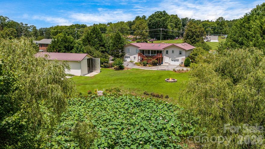 Set on 1.88 acres, this property offers 3,590 square feet on the main level and 1,377 square feet of finished space downstairs. The flexible layout includes three bedrooms, an office with a closet, a bonus room with a closet, three full baths and a half bath. A steam shower adds a touch of spa-like luxury. The expansive interior effortlessly accommodates a variety of pursuits, whether you need a woodworking or crafting area, a studio for artistic projects or a dedicated work-from-home space. A four-car tandem garage supplies abundant parking and storage, and a separate RV garage is equipped with 220-volt power, water and a utility sink. A generator provides peace of mind.  The no HOA property, county taxes only, features a lily pond and park-like grounds for a serene wildlife backdrop.  Combining generous square footage, versatile spaces and natural beauty, this home offers flexibility and tranquility in one unique package. Home includes six TVs, three refrigerators, and a washer and dryer.