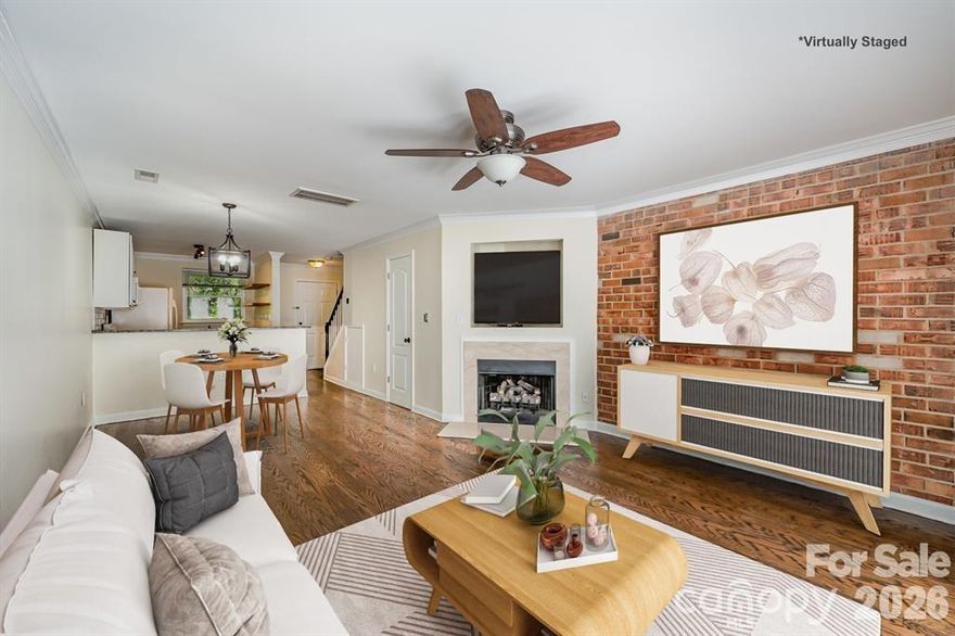 Updated condo walking distance to Plaza Midwood!! This beautifully updated 2-bedroom, 1.5-bath condo lives like a townhome and offers modern comfort with classic charm in an unbeatable location. Step inside to discover refinished hardwood floors throughout the main level, leading you to a stunning exposed brick accent wall and gas fireplace in the living room. The updated kitchen features granite countertops, a sleek subway tile backsplash, and floating shelves for a modern, charming feel. This home has been thoughtfully upgraded with a tankless water heater (installed 2022), new washer and dryer (2023), new windows (in kitchen and bedrooms 2023), new toilets (2023), new blinds (2024), and new concrete poured for the back patio (2024). Just minutes from the vibrant energy of Plaza Midwood and Uptown Charlotte, this home blends convenience with character. Don’t miss your chance to own this move-in ready gem in a highly sought-after location!