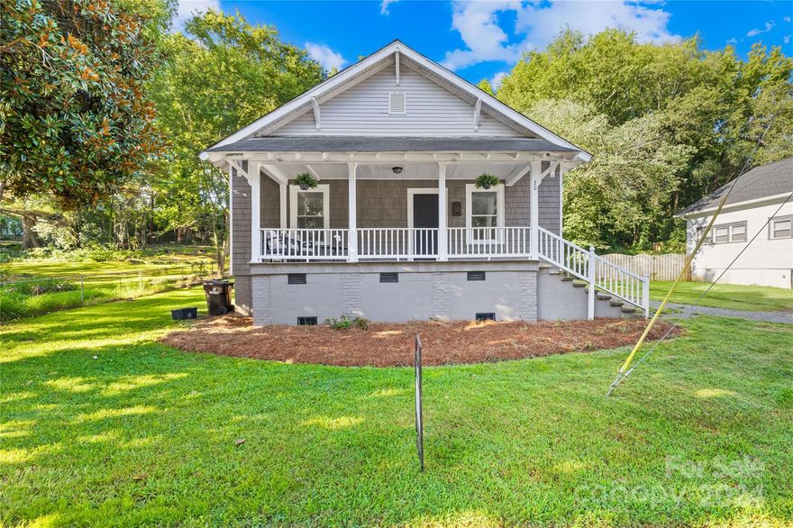 Classic appeal, modern living. Totally remodeled in 2018, and right beside the Rock Hill Greenway! The front porch greets visitors & provides a comfortable space to relax. Redesigned floor plan provides open space between the living room, kitchen, and dining area. The kitchen features a designer feel w/ white cabinets, subway tile, quartz counters, stainless farm sink, glass door upper cabinets, & top-end stainless appliances. Luxury vinyl plank and ceramic tile throughout. Recessed lighting, 9' ceilings, and barn-door accents enhance the modern styling. Primary bedroom features 2 closets, a shared luxury primary bath between the 2 bedrooms with a ceramic tile shower. The half bath is conveniently located off the living area. The laundry has space for larger appliances & provides a convenient exit to the back deck that overlooks the backyard that's perfect for raised-bed gardening. Walkable location convenient to downtown Rock Hill or Manchester Meadows. Short commute I-77. And NO HOA!