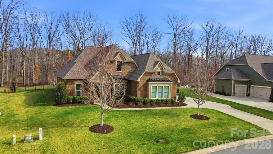 Welcome to a rare opportunity to own an all-brick 1.5 story home in the popular Adelaide Estates neighborhood with a HEATED INGROUND POOL! Offering over 3,100 square feet of exceptional living space on nearly a full acre with wooded views in the Weddington school district. This is the home that buyers wait for, and it’s finally here. From the moment you arrive, the brick exterior and expansive three-car garage set the tone for quality and craftsmanship. Step inside and you’re greeted by engineered hardwoods that span the entire first floor, creating warmth, durability, and seamless flow throughout the main living areas. The thoughtfully designed open floor plan is ideal for both everyday living and entertaining. At the heart of the home, the spacious family room features a stunning stone fireplace flanked by custom bookcases on each side — a true focal point that adds character and charm. Natural light pours in, highlighting the neutral palette and inviting atmosphere. The kitchen opens effortlessly to the living and dining areas, keeping everyone connected. Whether hosting holiday gatherings or casual weeknight dinners, this layout was designed with functionality and comfort in mind. A dedicated office is positioned at the front of the home, offering privacy for remote work, study, or a quiet retreat. The split-bedroom layout provides added privacy, with secondary bedrooms connected by a convenient Jack-and-Jill bathroom. The spacious primary suite is a peaceful escape, thoughtfully separated from the secondary bedrooms for maximum privacy. Upstairs, you’ll find a versatile loft space perfect for a media room, playroom, workout area, or second living space. A full bathroom and additional bedroom upstairs make this level ideal for guests, teens, or multi-generational living. Step outside and experience your private backyard oasis. Built in 2023 by Alaho Pools, the saltwater gunite pool and spa create a resort-style setting right at home. Whether enjoying a summer afternoon swim, relaxing in the spa on a cool evening, or entertaining friends' poolside, this backyard was designed to impress. The covered patio provides the perfect shaded retreat for outdoor dining and lounging. With almost a full acre of wooded views, there’s room to breathe, play, and unwind — all with added privacy and space that’s increasingly hard to find. This home offers the rare combination of timeless all-brick construction, modern open-concept living, a premium backyard experience, and a prime location close to shopping, and restaurants — all on a generous lot. Opportunities like this do not come often. Act NOW! Homes like this don’t stay on the market for long. Schedule your private showing today and experience everything this remarkable home has to offer.