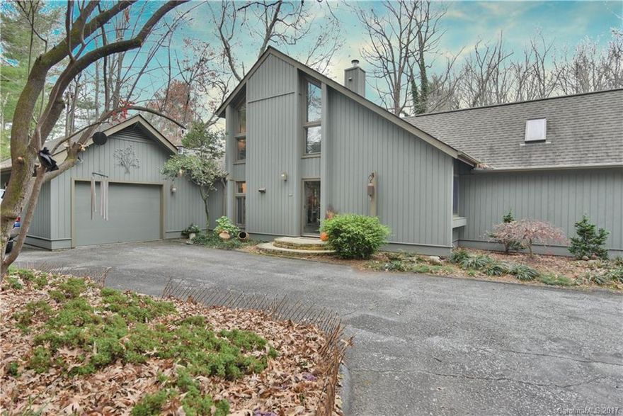 Striking contemporary home in Laurel Park on private 1 acre lot surrounded by natural fauna and a creek. New custom kitchen done in 2017 with top of the line appliances. Main level boasts laundry room with storage and master bedroom with sounds of the creek. Home has 2 gas fireplaces, loft perfect for guests with bonus area, and a workshop in basement. Excellent natural light and a great back deck. Yard is fenced for your furry friend. Radon mitigation system already in place.