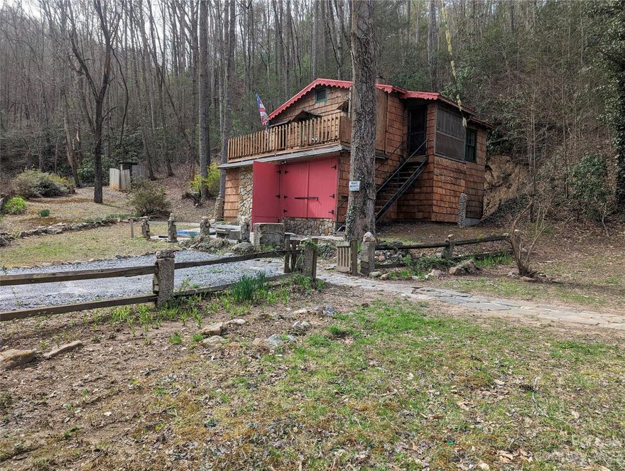 Unique cabin on app 2.5 acres bordering Hwy 90 and the Pisgah National Forest! A great opportunity for sportsmen to use as a home base, or nature lovers that desire to hike in the Forest, or folks to just get away from it all. The peaceful sounds of a babbling brook, across the road from the property, can be enjoyed from the top front deck.  There is a nice woodstove in the living room and one in the lower level. The home is fully functional with 2 beds, 2 baths, kitchen with refrigerator, electric range, microwave and sink, and wet bar/entertainment area in lower level.   A vintage wood cook stove in the kitchen can be negotiable. Keep in mind that this home was estimated to be built in 1930 and the water source is a spring sourced in the Nat.Forest, with tank and pump located on adjacent property, but power supplied by subject property. No septic records, but septic is currently functioning as intended. No permits discovered.  12 scenic miles to town of Blowing Rock, via Globe Rd.