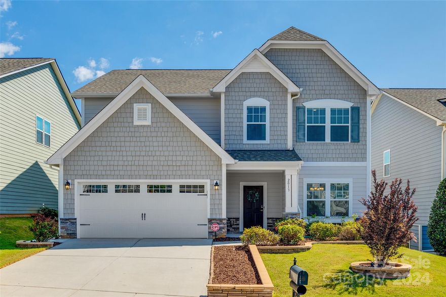 Experience the epitome of luxury living in this meticulously maintained, like-new, 5 bedroom, 3 full bathroom two-story home in Tega Cay. Step inside to find an inviting layout with gleaming luxury vinyl plank floors, custom molding and abundant natural light. The gourmet kitchen is a chef's dream with granite countertops, stainless steel appliances and tile backsplash. Retreat to the spacious primary suite with a spa-like ensuite bath featuring a dual vanity sink, garden tub and stalled shower. Upstairs, three additional spacious bedrooms and full bathrooms offer ample room for guests. The in-law suite offers privacy on the main floor. Outside, enjoy a landscaped backyard complete with a custom pergola that's fully wired for electrical, TV mount and custom pull down shade to provide a backyard oasis. Plus, a fully insulated and finished oversized 2-car garage with epoxy flooring, providing space for storage and hobbies. Enjoy all the amenities available in this vibrant community.