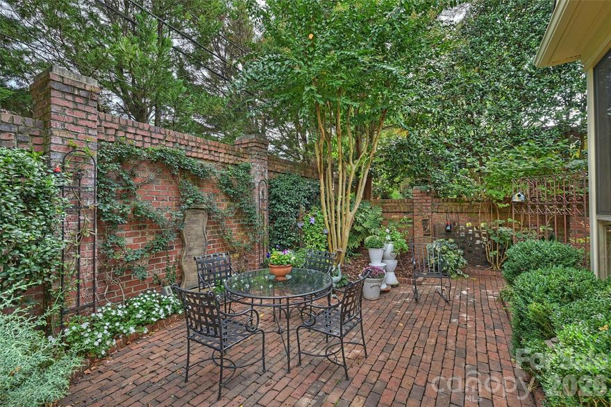 Located in the heart of Myers Park, this Simonini-built residence at Myers Park City Homes offers timeless architecture, modern luxury, and unmatched convenience. A MUST SEE, Lives like a Single Family Home. Private back yard and gardens! And full season screened porch.

The main level features an open-concept layout with a spacious primary suite (including office/study), a chef’s kitchen with large walk-in pantry, dining room with fireplace, and a sunroom that opens to a private terrace—ideal for entertaining. Hardwood floors throughout, abundant natural light, and generous storage enhance every space.

Upstairs you’ll find three bedrooms, three full baths, a cedar closet, and a large bonus room with built-in bar, office, and extra storage. A permanent staircase leads to a 440 SF walk-up attic. 

Tucked behind secure gates, this home includes a private garage and low-maintenance living. Residents enjoy tree-lined streets with close proximity to Uptown, SouthPark, Freedom Park, and Charlotte’s greenway system, along with the area’s premier dining, shopping, and cultural destinations.