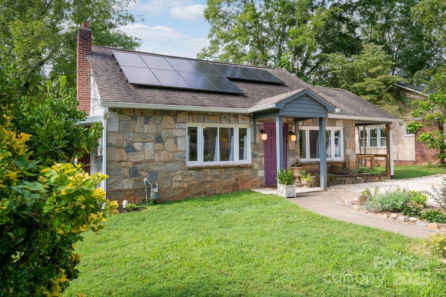 Welcome to this beautifully updated 1950s home where modern convenience meets classic West Asheville charm. This house has a main living area with two bedrooms and two full bathrooms, as well as a secondary living space with its own private entrance on the basement level, perfect for a guest suite, in-law quarters, or a potential rental (previously a successful Airbnb). Step into a warm and welcoming open floor plan highlighted by a cozy gas fireplace. The updated kitchen is complete with quartz countertops, stylish tile backsplash, LG stainless steel appliances, and modern finishes. The primary bedroom boasts a private ensuite bath, and both bedrooms include clever built-in closet solutions. Pull down-stairs lead to a large attic space ready for your vision. Outside, the vinyl and rock façade lends a charming cottage feel. Energy-efficient solar panels, a newer HVAC system, and a one-car garage with two additional off-street parking spots provide both comfort and practicality. Situated just minutes from all that West Asheville has to offer, this home is a rare find that combines location, flexibility, and character.