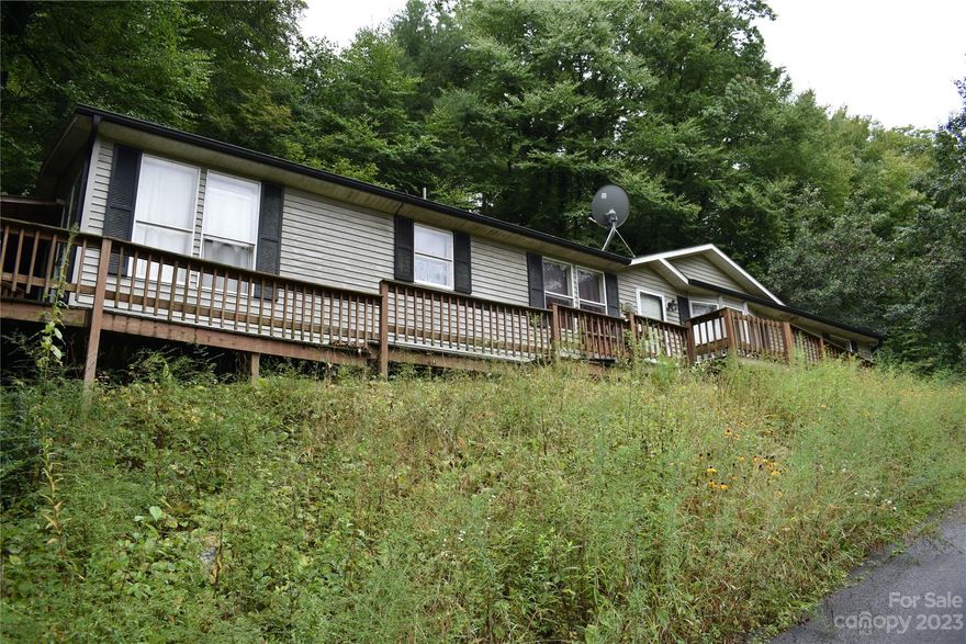 3 bed 2 bath manufactured home 30 min from Asheville. Large fenced dog run. Paved driveway and parking area. Primary Bedroom has Bathroom with Garden Tub and separate shower. Skylights in bathrooms and kitchen. Back bedrooms has no flooring. Be careful on ramp and deck. Surface is slippery.

Property being sold as-is//where-is. Buyer to verify all information. Listing Agent and Seller make no representations. Exempt from RPD and MOG. This is a court ordered sale and the final negotiated offer will be presented to the court for final approval. Once approved, the offer is subject to a 10-day upset bid administered by the Madison County Clerk of Court. Real Estate Office does not hold Earnest Money. We are waiting on conformation for the water and septic. No electric or water is on.