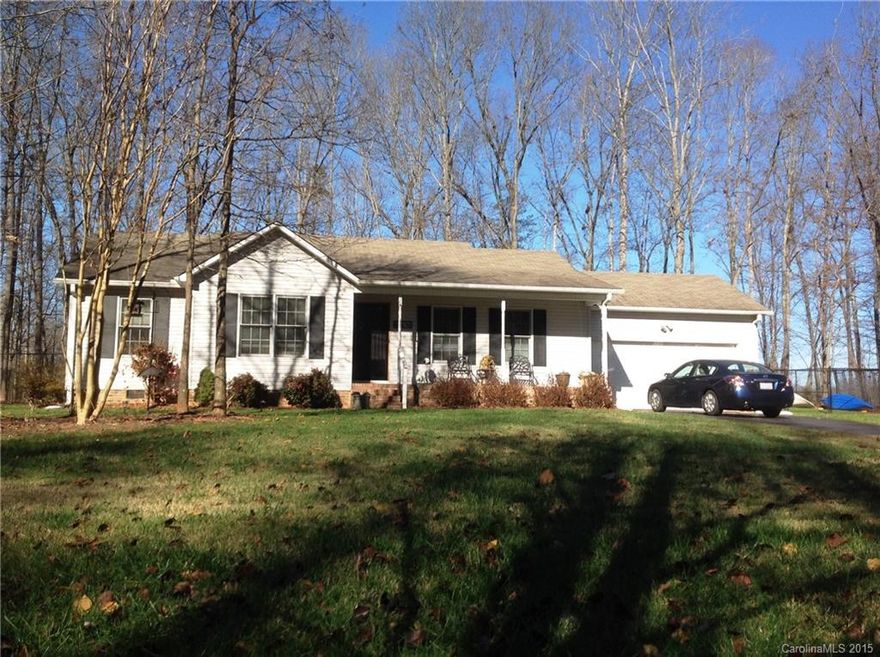 CUTE AS A BUTTON! This country charmer is priced right, in a great location, and shouldn't last long! Large, private, fenced back yard, perfect for entertaining with large deck complete with bbq pit, pretty landscaping, and nothing but woods and country fields all around! Close to I40 for easy commutes, yet sits on quietly on a dead-end road, convenient to everything, with desirable schools. Garage can still be used for your car, or can sub for a bonus room with a real wood-burning fireplace!