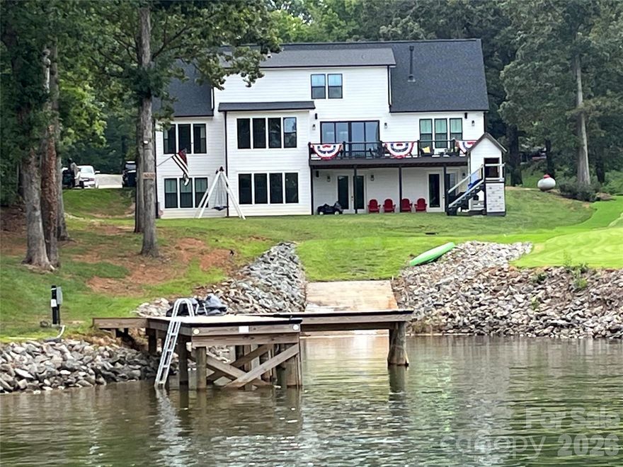 Discover the ultimate Lake Norman lifestyle at this exceptional waterfront residence, complete with the rare convenience of a grandfathered private boat ramp for effortless access to the water.  This unique waterfront cove is distinguished by a natural spring flowing through it, enhancing the shoreline with a peaceful, organic element that brings beauty, character, and purification to the lake living experience.  Perfectly positioned to capture unobstructed lake views, this classic, custom home blends timeless design with a modern twist in one of the area's most sought-after settings.

Situated at the end of an extended driveway for added privacy, you are met with striking curb appeal and a tranquil atmosphere. Enjoy just under 3 acres of one of the few coveted large lots on Lake Norman.  The neighboring equestrian facility further enhances the picturesque landscape.  Inside, expansive windows fill the space with natural light while framing picturesque year-round water views throughout the main living areas. The functional floor plan provides livable luxury.  It's ideal for both everyday living and upscale entertaining, featuring refined finishes, custom craftsmanship, and seamless indoor-outdoor flow.

At the heart of the home, the gourmet kitchen offers premium appliances, generous cabinetry, and a spacious island—perfect for gathering with family and friends after a day on the lake. The primary suite serves as a retreat with calming water views and a spa-inspired En suite.  The additional bedrooms and living spaces provide limitless flexibility, comfort, and privacy for guests.

Outdoor living is where this property truly shines. Enjoy peaceful mornings by the water in this quiet cove, sunset evenings, and the convenience of your private boat ramp and dock.  Spontaneous activities like boating, paddleboarding, jet skiing, and fishing can be part of your everyday life. Whether hosting lakeside gatherings or enjoying simple moments on the shore, this property delivers an elevated waterfront experience.  

Ideally located near shopping, dining, healthcare, and everyday comforts—yet offering the sought-after benefits of lakefront living—you will find your own sweet slice of waterfront paradise here!
Motivated sellers!!