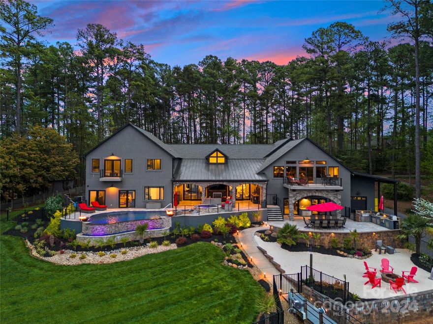 Indulge in the epitome of luxury living in this waterfront sanctuary. Command your environment effortlessly in this Control4 smart home from lighting to security. Step outside to a haven of outdoor living; terraces & balconies offer intimate spaces for relaxation with breathtaking views of the lake & your private dock. The infinity pool beckons for leisurely dips while you entertain with ease at the outdoor grilling station & bar, complete with an ice bucket & beverage fridge. An indoor heated/cooled entertainment space with a full bar promises year-round enjoyment. High-end finishes & appliances throughout the home & every thoughtful convenience is at your fingertips. An attached second living quarters, perfect for guests. Floor plan has spaces to meet every need. There is even a show garage for luxury vehicles. Can be sold furnished. This Lake Norman home is a total masterpiece of modern luxury, and every detail is curated for the ultimate lifestyle experience.