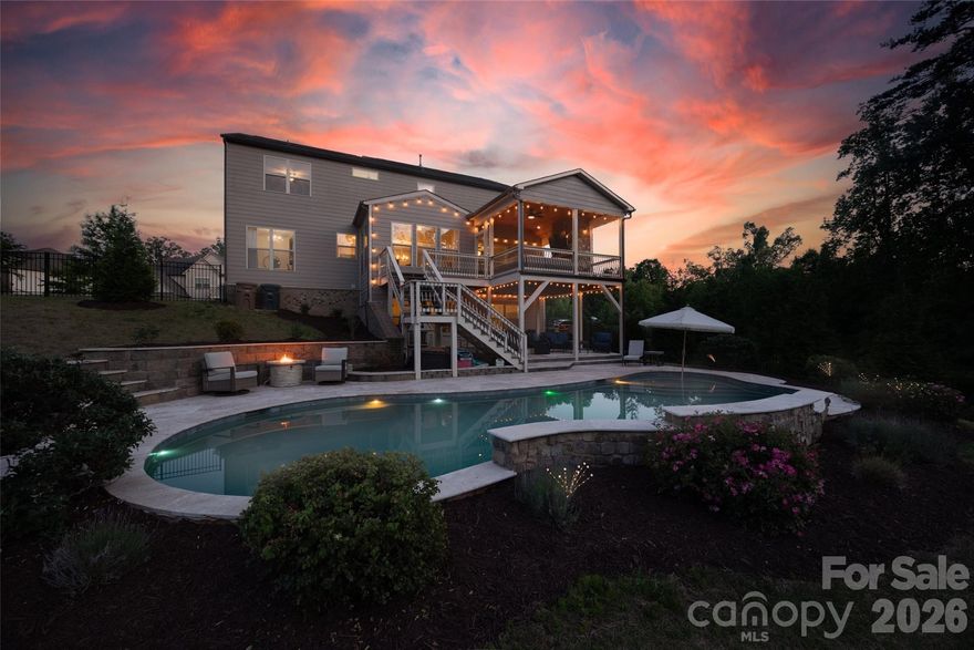 This stunning Millbridge masterpiece is the perfect family home, offering resort-style living right in your backyard. The incredible outdoor oasis features a HEATED in-ground Gunite pool, a spacious beach SAND play area for the kids, and a stunning vaulted covered porch (ready to screen if desired) with a stone fireplace—creating the ultimate space for family fun and unforgettable memories. Nestled on a premium 0.35-acre lot backed up to a WOODED area offering exceptional PRIVACY that sits beside a lush green space with direct access to the community walking trail that leads to the Clubhouse. Inside, new luxury vinyl plank flooring on the first two levels adds durability and style for busy families. The thoughtfully designed home has a surprise awaiting around every corner with a flexible layout boasting 6 bedrooms PLUS 2 additional guest/bed/flex rooms in the basement—ideal for multi-generational living or a private suite. Families will especially love the dedicated toy room—perfect for keeping playtime organized and contained! Additional features include a convenient side-load garage, abundant natural light throughout the home and plenty of STORAGE.  Millbridge is packed with family-friendly amenities including multiple pools with splash pads, lazy river, walking trails, tennis/pickleball courts, a fitness center, and so much more. Top-rated Cuthbertson schools and easy access to shopping make this location incredibly convenient for growing families. A true stunner that feels like vacation every day—Enjoy showing!