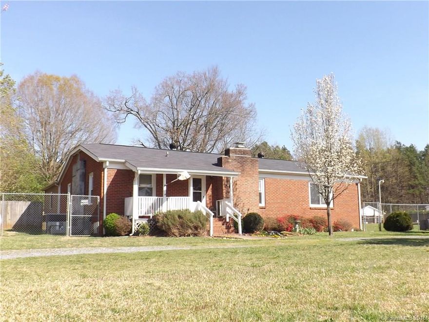 FANTASTIC OPPORTUNITY FOR MULTI PURPOSE PROPERTY. Lots of updates with detached 2 bay 30x30 garage, 60x30 garage with 220 electricity. and compressor lines zoned B4 and 4 stall barn with chicken house. 6 foot fence surrounds property with 5 paddock areas. Huge country kitchen. New laminate flooring. Laundry room set up for dog grooming.  Office was built as storm shelter and is a multipurpose room with outside access. Great master bath with claw-foot tub, tiled shower and raised double vanity.