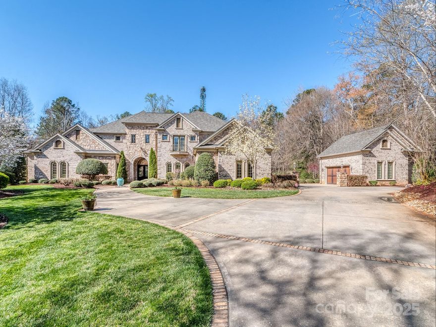 Situated on nearly 5 acres just minutes from Lake Wylie, this stately custom-built estate is both an entertainer’s dream & a private retreat. Boasting 5 bedrooms & over 7,500 sq. ft., it offers exceptional space for hosting in style. The main level features a luxurious primary suite, guest bedroom, & elegant formal living/dining room w/ vaulted ceilings & custom beams. The impressive two-story great room showcases a gas fireplace & a full bar w/ wine storage, wine refrigerator, ice maker, & kegerator. The chef’s kitchen is a masterpiece, featuring Wolf appliances, built-in espresso machine, spacious island w/ prep sink, & walk-in pantry. Designed for both relaxation & entertainment, this home includes a movie theater, gym with a sauna, & expansive outdoor living area. The covered patio is equipped w/ built-in grill, pizza oven, fryer, & wood-burning fireplace. Step outside to enjoy the resort-style pool and hot tub, all complemented by ample parking, & two 2 car garages.