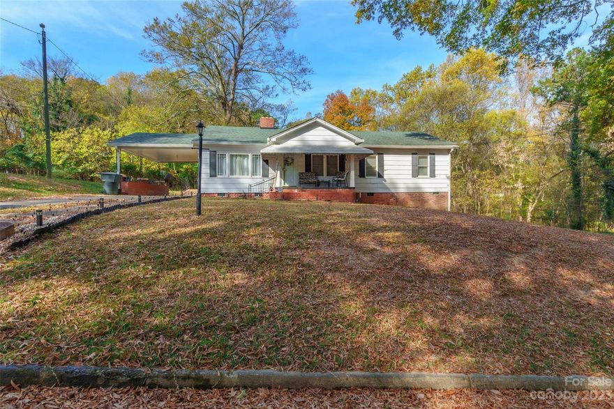 Step into comfort and warmth in this cozy 3 bedroom, 1.5 bath Ranch home, where the allure of a warm fireplace meets you in the living room as you arrive.  Discover convenience and comfort in the 3rd bedroom's clever 1/2 bath Jack & Jill setup.  Venture outside to to find a convenient carport, a side entrance ramp and a large backyard.  The enclosed, covered porch offers a peaceful spot to look out to the expansive backyard that overlooks the woods.  This home is situated on just under an acre.  Priced attractively, this property presents an ideal opportunity to convert into homeownership! Home is being sold as-is.
