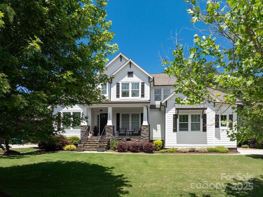 Beautiful home in the Highly sought after Springfield community in Fort Mill, SC checks all your DREAM home boxes. Unique,handcrafted elements are complemented by a spacious and welcoming floor plan offering 5 bedrooms and 4.5 baths. Set your sights on relaxation with your very own Private outdoor oasis with an inground salt water gunite pool & grotto to the Rocking chair front porch. As you enter through the front doors, your eyes are welcomed by a wall of windows for natural light and the warmth of real hardwood floors. You will fall in love with the custom built sunroom/gathering room elevated w/a stacked stone fireplace. The chefs kitchen is an entertainers dream w/SS appliances; quartz countertops; built in oversized island & custom bar. A lavish primary suite on the main level w/custom vaulted ceiling and wood beams. Additionally you will find a Seperate home office; Guest Suite & full bath on the main floor as well as 3 additional bedrooms upstairs PLUS a media/recreation room.