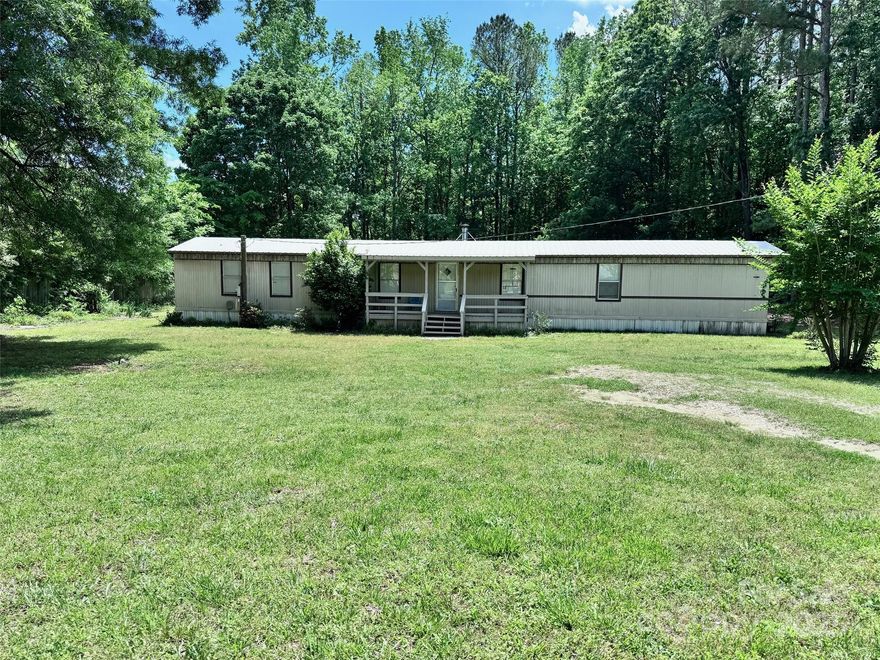 Enjoy peaceful country living on this spacious 2-acre property, offering privacy, space, and room to roam. The refreshed 3-bedroom, 2-bath home features an open floorplan with an inviting layout that flows easily from room to room. Covered front and rear porches provide the perfect spots to relax and take in the surroundings. Outside, the fully fenced yard is ideal for pets, gardening, or outdoor activities, and two storage sheds offer plenty of room for tools and equipment. The back half of the property is wooded, creating a natural buffer and a quiet, scenic setting. A private trail winds through the trees, leading to a creek at the rear of the property—great for exploring, unwinding, or simply enjoying the outdoors.  No HOA; no city taxes.