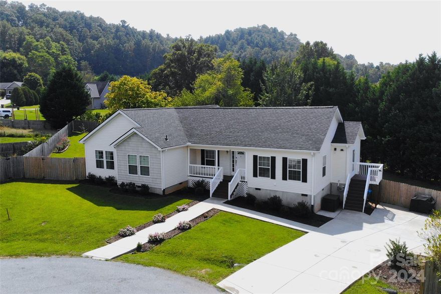 Enjoy the quiet countryside surrounded by the beautiful mountains of Western North Carolina.  This meticulously maintained house is perfect for anyone looking for an updated move-in ready home with plenty of space, including a large freshly remodeled primary bathroom and brand new kitchen. Step outside to discover a large, fenced-in yard that is perfect for pets and provides plenty of space for outdoor activities, gardening, or simply relaxing in the sun. A new roof was installed in 2024.