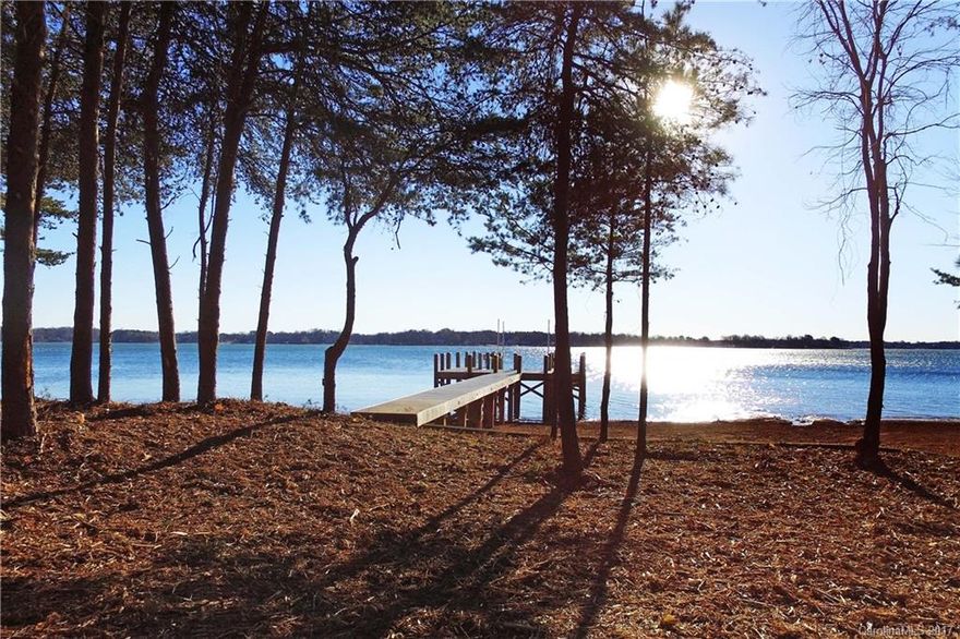 VILLAGE WATERFRONT LOT.  Private Pier and Seawall installed. Dredged pier area.  Main Channel view and walking distance to all Club Amenities. Current Septic permit for 5 bedrooms.  Generous 100' X 75' building envelope.  Rare find in The Point!  Use one of The Point approved builders or bring your own builder. (must be approval). Beautiful location for your dream waterfront home!