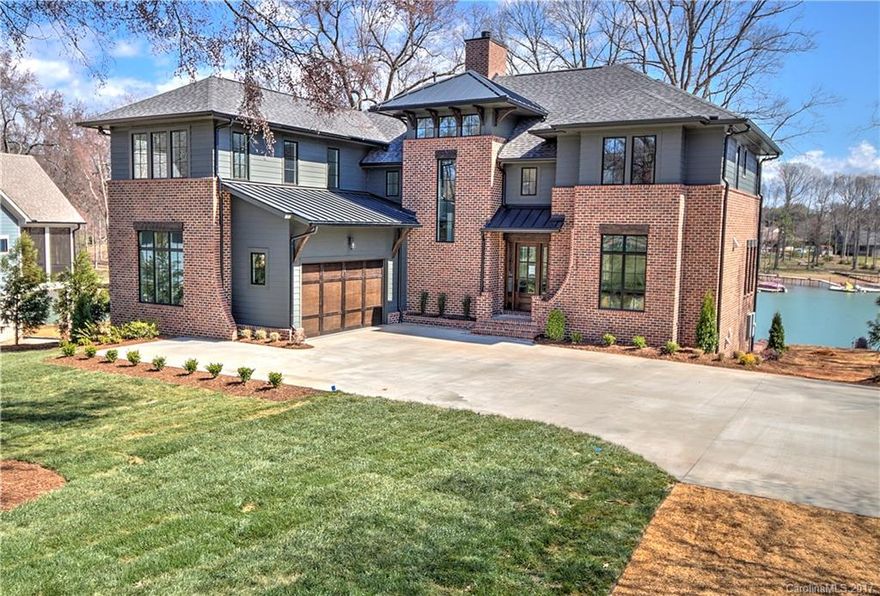 Grande Custom Builders with a master piece on Lake Norman! A Beautiful floor plan featuring a 16' sliding pocket door that opens to your outdoor covered porch, making this the ultimate entertaining house. A master on main with excellent water views and a professional kitchen complete with Wolf/Sub-Zero appliances. Every bedroom has a water view and featuring elegant, clean finishes. A private setting and beautiful large oak tress give it that spa feeling you have been looking for. Ready Now!
