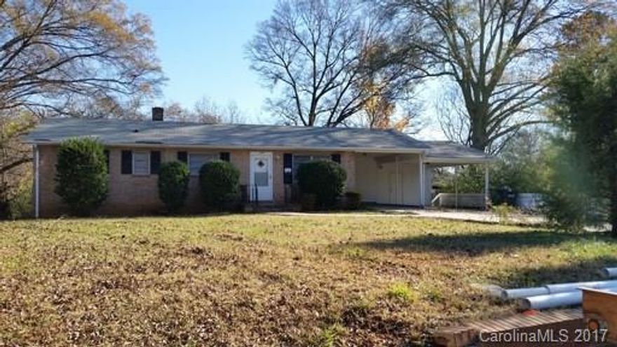 Brick ranch with 3 bedrooms and 1.5 baths. 2 car carport with 2 storage rooms. Large backyard- almost half an acre. New septic.