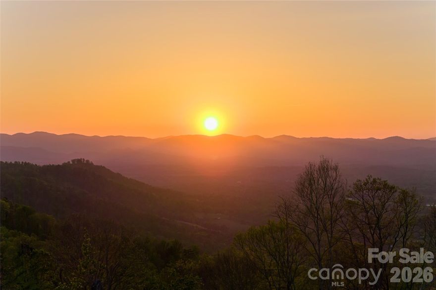 Set high above the valley floor along the storied Elk Mountain Scenic Highway, this offering presents a rare opportunity to shape your own mountain legacy. Perched at elevations above 3,000 feet, the land unfolds across a dramatic landscape of ridgelines, gentle saddles, and elevated knolls—each naturally positioned to capture sweeping, year-round views of the Blue Ridge Mountains. Defined by both scale and topography, the property is enriched by mature hardwood forests that provide privacy and seasonal color, while the rolling terrain reveals multiple natural homesites with exceptional view corridors. Subtle elevation changes, quiet hollows, and winding streams add dimension and texture, creating a setting ideal for thoughtful land stewardship. The landscape invites the creation of a signature mountain residence complemented by private trails, curated gardens, and outdoor living spaces immersed in nature. Final acreage to be determined. Despite its remarkable sense of seclusion, the property is only minutes from Asheville’s celebrated dining, arts, healthcare, and everyday conveniences, including the Country Club of Asheville and the Blue Ridge Parkway. This balance of elevation, accessibility, and natural grandeur is increasingly rare. Whether envisioned as a private mountaintop retreat, multi-generational compound, or long-term investment, this offering provides the freedom to create something enduring in one of Western North Carolina’s most iconic high-elevation corridors. A separate MLS listing is available offering additional contiguous acreage for those seeking to expand the scale of their vision.