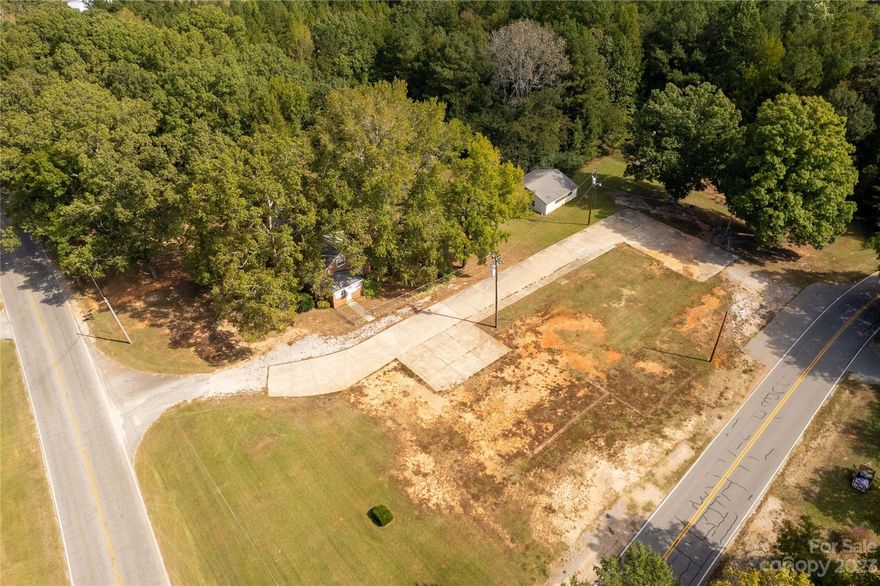 Lots of opportunity to own a home with acreage or subdivide. Several homes can be built on property which is flat clear acreage. Home is move in ready. Large storage or workshop out back. Road frontage on 2 streets.