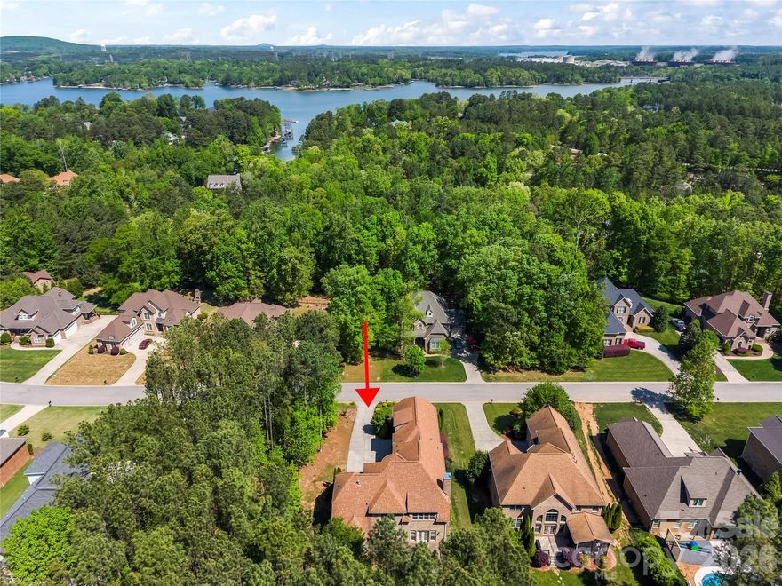 This is the one you've been waiting for. Tucked away in a quiet, established enclave, this full brick custom home stands out with its mature, lush landscaping, timeless architecture, and undeniable curb appeal. Step inside to soaring ceilings, rich wood flooring, and extensive crown molding, all elevated by an abundance of natural light pouring through its windows that come equipped with custom Roman UVA blinds. The open, airy layout is designed for both everyday comfort and effortless entertaining, with seamless flow between living spaces. A major highlight is the main-level primary suite, offering convenience, privacy, and long-term livability. Each of the four bedrooms features its own private full bath, creating ideal separation for guests or family. A dedicated study provides the perfect space for working from home or quiet retreat. Out back, enjoy a low-maintenance Trex deck overlooking a private setting framed by mature landscaping, perfect for relaxing mornings or evening gatherings. Backyard has plenty of room for a pool, just in case it's in your future plans. Additional features include a rare oversized tall 3-car garage, in-ground irrigation and a top-of-the-line prewired security system with motion sensors. The community of Palm Tree Cove offers a pool, walking trails, and dedicated storage for boats, RVs, jet skis, and trailers. Located in the highly regarded Clover School District ( new Lake Wylie High School), low/desirable SC property taxes, and just a short drive to shopping, dining, medical facilities, and Charlotte Douglas International Airport. This one is a must see!