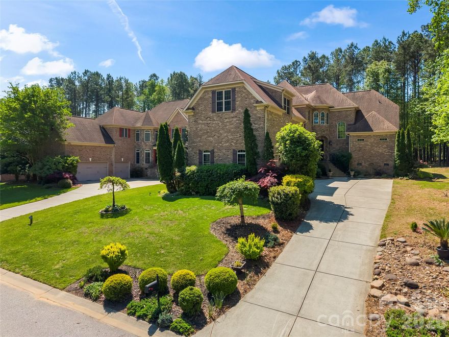FROM THE MOMENT YOU ARRIVE, THIS CUSTOM FULL BRICK HOME DELIVERS THE KIND OF WARMTH, PRIVACY, AND PRESENCE BUYERS RARELY FIND ANYMORE. Tucked away in a quiet, established enclave, this full brick custom home stands out with its mature, lush landscaping, timeless architecture, and undeniable curb appeal. Step inside to soaring ceilings, rich wood flooring, and extensive crown molding, all elevated by an abundance of natural light pouring through its windows that come equipped with custom Roman UVA blinds. The open, airy layout is designed for both everyday comfort and effortless entertaining, with seamless flow between living spaces. A major highlight is the main-level primary suite, offering convenience, privacy, and long-term livability. Each of the four bedrooms features its own private full bath, creating ideal separation for guests or family. A dedicated study provides the perfect space for working from home or quiet retreat. Out back, enjoy a low-maintenance Trex deck overlooking a private setting framed by mature landscaping, perfect for relaxing mornings or evening gatherings. Backyard has plenty of room for a pool, just in case it's in your future plans. Additional features include a rare oversized tall 3-car garage, in-ground irrigation and a top-of-the-line prewired security system with motion sensors. The community of Palm Tree Cove offers a pool, walking trails, and dedicated storage for boats, RVs, jet skis, and trailers. Located in the highly regarded Clover School District ( new Lake Wylie High School), low/desirable SC property taxes, and just a short drive to shopping, dining, medical facilities, and Charlotte Douglas International Airport. Sellers own .40 acre lot next to house which is also for sale - 279 Palm Cove Way - just in case you would like that one too for additional privacy or to eventually build on. This is more than a home-it’s the kind of property buyers wait years to find.