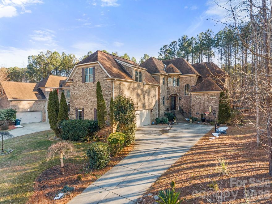Be prepared to fall in love! Tucked away in a peaceful enclave just minutes from Allison Creek State Park (located on the shores of Lake Wylie), this full brick & textured stone exterior timeless "castle like design" custom home offers an exceptional blend of refined living & natural tranquility. Thoughtfully designed & very well maintained, the home exudes timeless elegance with solid construction, graceful architectural lines, & an inviting presence. From the moment you arrive, you will notice the soaring vaulted ceilings, open floor plan, UVA protected Roman blinds, plush wood flooring & crown moulding throughout. Inside, generous living spaces are filled with natural light, creating a calm & welcoming atmosphere ideal for both everyday living & effortless entertaining. The layout flows seamlessly, offering comfort, privacy, and versatility throughout. All 4 bedrooms have their own private full bathroom. Seller enjoys spending solitude time in the peaceful study room. Whether enjoying quiet mornings or hosting intimate gatherings, this home delivers a sense of ease and sophistication. 2025 water heater, trex back yard deck, top of the line security system (prewired throughout) with motion sensors, front & side inground irrigation. Oversized three car garage. Mature landscaping & trees. HOA includes boat/rv/jet ski & trailer storage, pool & walking trails. Award winning Clover schools, short driving distance to Charlotte airport, shopping, hospitals, restaurants, trails & low SC property taxes are a big plus!