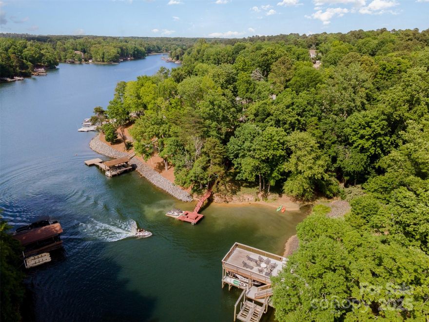 Why just live near the lake when you can live on it? This waterfront beauty is made for paddle boarding, kayaking, and everyday adventures. Main-level primary suite with ensuite bath and deck access, plus 3 bedrooms and a loft upstairs. Fresh paint, brand-new stainless-steel appliances, new fixtures, and no carpet anywhere—just clean, new flooring. The light-filled two-story living room features a cozy fireplace and stunning floor-to-ceiling windows. Bonus perks: walk-in attic, freshly painted garage floor, and a spotless crawlspace. A mile to Windjammer Beach, golf, clubhouse with restaurant, trails, pickleball, tennis, and Fort Mill’s top-rated schools. Seller is offering up to $5,000 to help buy down your interest rate—making your monthly payment more affordable!