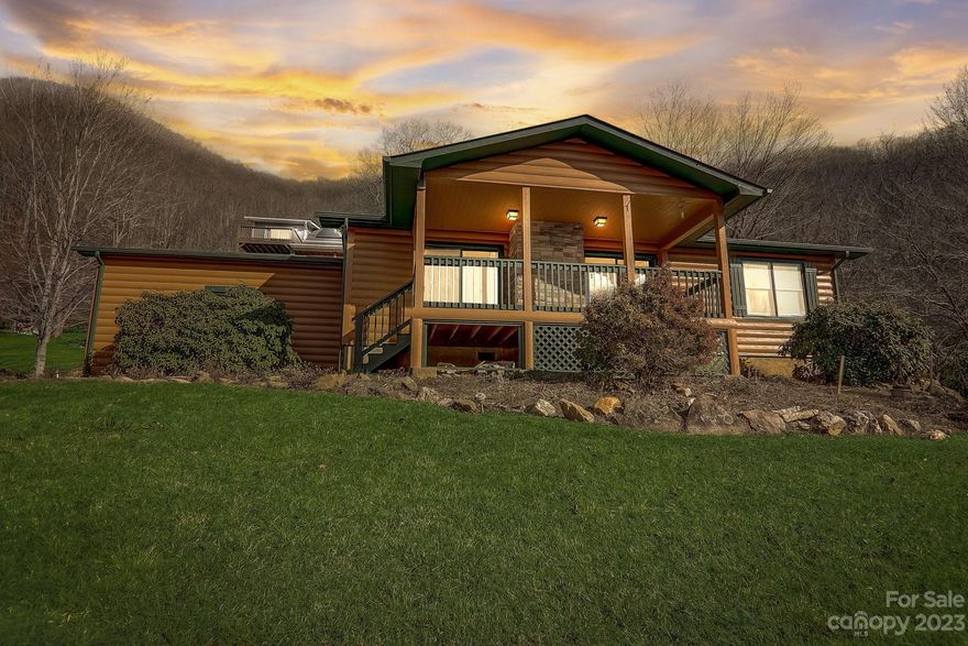 Outstanding year-round mountain views! Gentle, mostly paved access takes you to this one-level log-sided home overlooking the town of Maggie Valley and the long-range views beyond. The 2 bedroom, 2 bath home features one level living. The living room is vaulted with a wood-burning fireplace & twin door slider access to the covered porch to take in the views. Decent-sized kitchen with pantry & laundry closet just off the kitchen. The bedrooms are ample in size. There is one car carport and a detached outbuilding for storage. The exterior has been recently stained. Located in The Knolls subdivision you cannot find better views with such proximity to town.