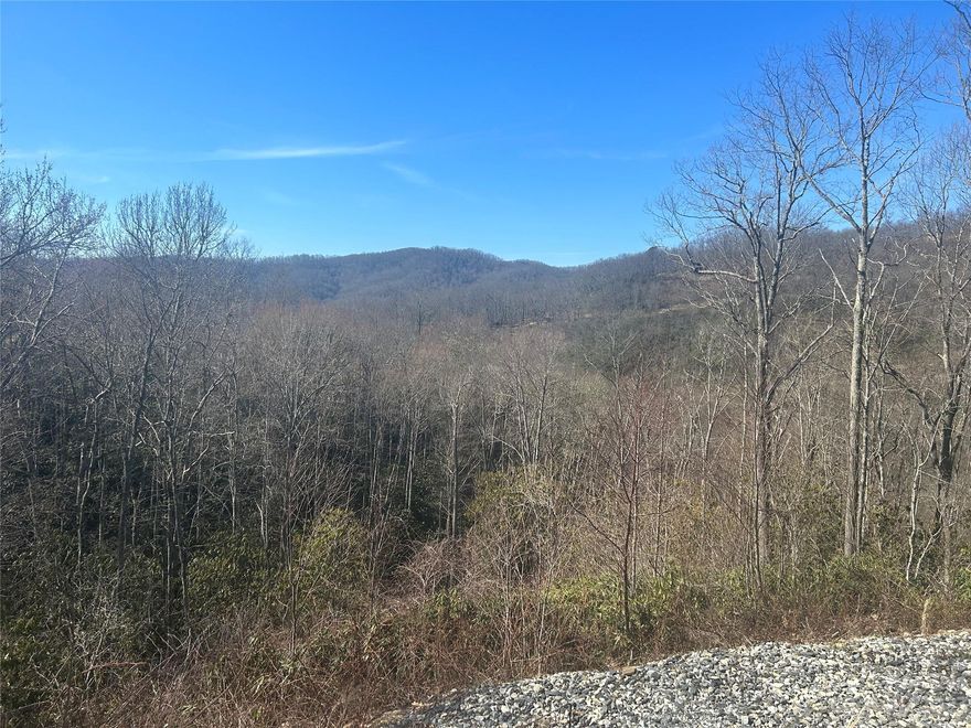 Long range views from this over 3-acre tract in beautiful Gated Alarka Highlands. High on top of the mountain with easy access. Build your mountain dream home here.