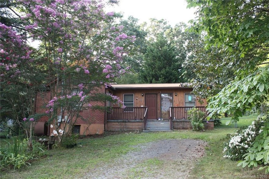 Easy one level living in desirable Grovemont. Affordable and ready for your personal touches. Features 2 spacious bedrooms, stone fireplace in living room/dining area, great room, front deck and large rear patio. Nice level yard with mature trees and space for garden. Short walk to library and playground. Quick drive to Asheville or Black Mountain.