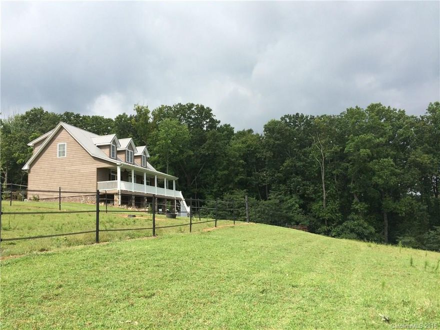 Gorgeous mountain views await in this custom home on 7.65 acres w/ fenced pasture &barn for your horses & walking trails at back of property for the nature lover. Immaculate home features custom details like wood floors, granite counters, SS appl, spacious master on main w/ spa-like master bath, open floorplan, 2 large BRs & bath up, spacious rec room below w/ full bath. Take in the sunrise from the covered front porch.  Terrific N. Iredell location convenient to Lake Norman, Winston & Hickory.