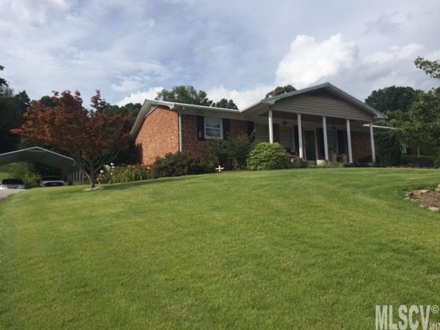 This charming 3bed/2bath brick home located across from the Wittenburg boat access to Lake Hickory. "Ready to move in" has hardwoods, laminate, and tile floors. Enter through back entrance and spacious foyer greets you. Bonus room/bedroom to your left and open dining/kitchen area leads you to living room and office, down the hall are the bedrooms. Firepit area just outside the bonus room/bedroom, landscaping is quaint. 2 car carport and ample parking. Metal roof in 2013, new water heater in 2012. Kitchen has Granite tile counters. Modern décor throughout. Launch the boat in minutes or play Ol Still golf course just minutes away. Just minutes from shopping.  Come check this one out before it's too late!!!