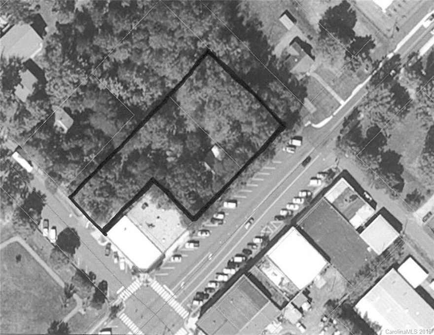 0.96 acres of unimproved commercially zoned property in the center of downtown Columbus, NC. Two parcels, C7-K6 & K7 with 197' frontage on 108 W (AKA West Mills Street) and 70' frontage on Peak Street. Old house on property of no value. Best use would be to grade property down to street level and construct 9-10 store fronts or subdivide into zero lot line parcels. Owner has another piece of property a short distance away that would accept the fill.