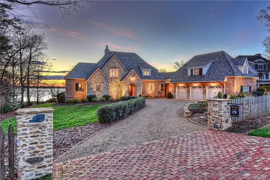 Unrivaled Lake Norman sunsets from every room of this recently completed one of a kind English cottage situated in the upper Jetton area of Cornelius & the Peninsula Club. This builder's home features timeless bespoke design and custom architecture such as exposed wood beams, custom Amish cabinetry, a stunning La Cornue gas range, with soapstone & onyx counters. A cozy covered veranda adjourns to lakeside seating & fire pit, private beach & dock, accented with an adjacent guest carriage loft.