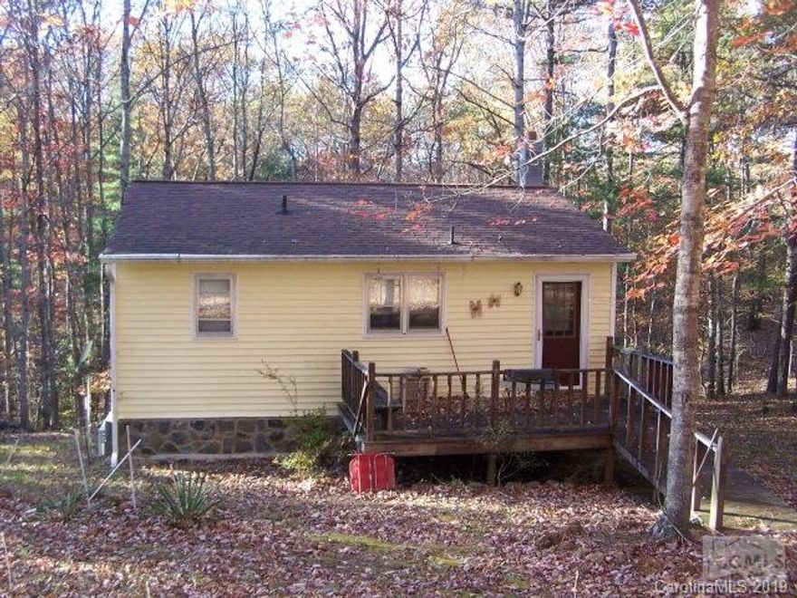 Complete privacy awaits you in this little home in the woods.  Located on 11+ acres, this cute cabin would make a great weekend retreat or starter home.  Basement could easily be finished for additional living space.