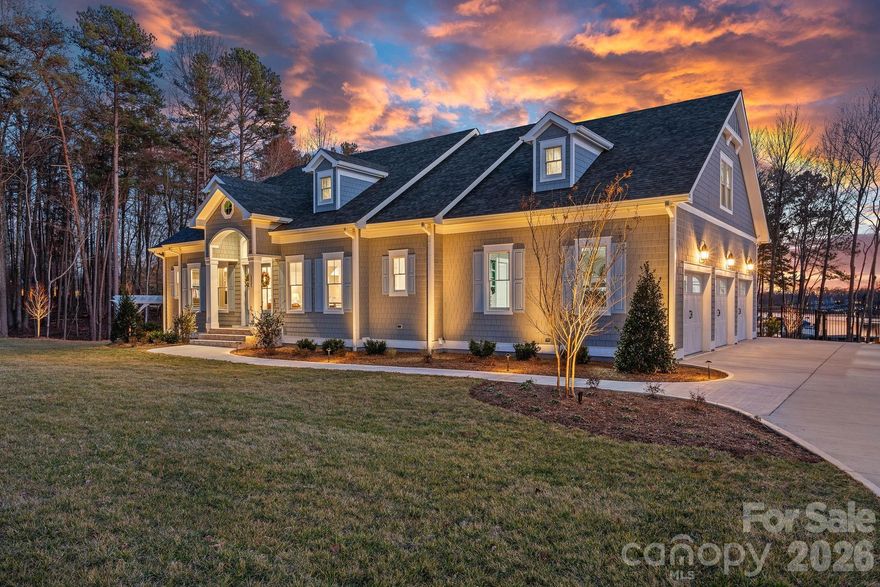 An exceptional opportunity to own a newly built waterfront estate in The Point. Completed in 2024 by Courtland Home Builders, this stunning residence was masterfully designed to embrace effortless lakeside living and refined entertainment. Perfectly positioned to capture expansive water views, the home embraces the beauty and serenity of lakefront living at every turn. Imagine mornings spent paddleboarding from your private waterfront setting and afternoons kayaking into golden sunset skies — this is the lifestyle Lake Norman is known for.

Drenched in natural light, the open-concept floor plan seamlessly connects the main living spaces while framing stunning lake views. The chef’s kitchen is the heart of the home, featuring an expansive island, custom cabinetry, and luxury appliances including Wolf, Sub-Zero, and dual Cove dishwashers. Extensive built-ins and exquisite moldings add architectural interest and timeless character throughout.

The main-level primary suite offers peaceful water views and a custom walk-in closet that truly impresses — thoughtfully designed and with space to accommodate a future stackable washer and dryer for added convenience.

Upstairs, three spacious bedrooms are complemented by an open loft with custom built-ins, offering endless possibilities — from a refined workspace to a quiet reading retreat. A versatile flex room with barn door provides additional space for an office, playroom, or den. A private guest suite with en-suite bath ensures comfort and privacy for visitors.

The fully finished lower level continues the home’s thoughtful design, offering a dedicated office with built-ins, en-suite bedroom, expansive family room, exercise/flex space, and a laundry room with built-ins and complete with laundry chutes from the upper two floors. Abundant walk-in storage adds to the home’s functionality.

Outdoor living is where this waterfront property truly shines. A saltwater pool and spa overlook the lake, creating a resort-style setting for sunset evenings, weekend gatherings, or quiet mornings by the water. The property includes boat slip Pier M #10, just a short walk away, with dedicated parking available — completing the ultimate Lake Norman boating lifestyle.

An exceptional blend of luxury, functionality, and true waterfront living — this is The Point at its finest.