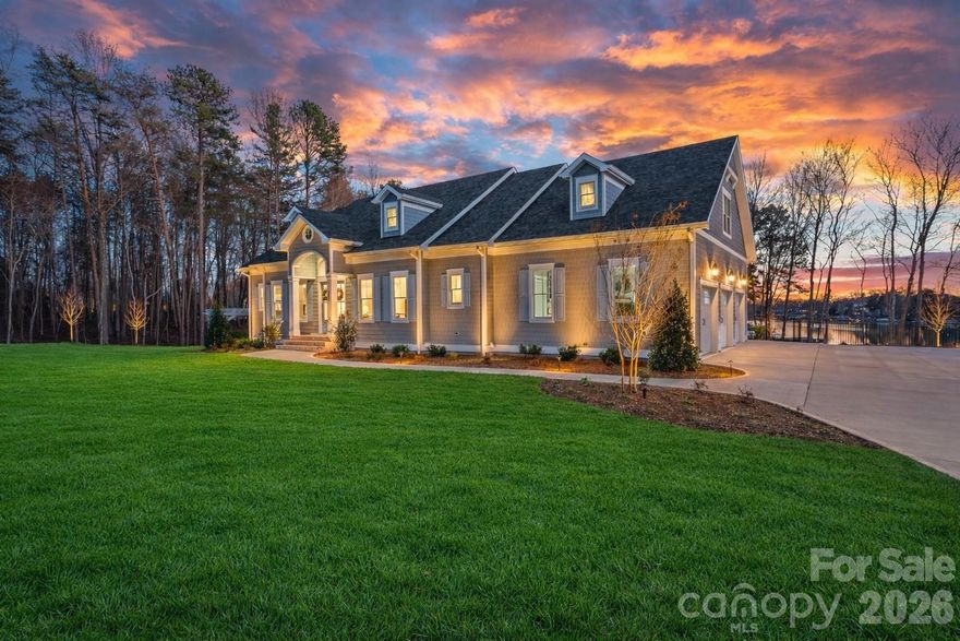 An exceptional opportunity to own a newly built waterfront estate in The Point. Completed in 2024 by Courtland Home Builders, this stunning residence was masterfully designed to embrace effortless lakeside living and refined entertainment. Perfectly positioned to capture expansive water views, the home embraces the beauty and serenity of lakefront living at every turn. Imagine mornings spent paddleboarding from your private waterfront setting and afternoons kayaking into golden sunset skies — this is the lifestyle Lake Norman is known for.

Drenched in natural light, the open-concept floor plan seamlessly connects the main living spaces while framing stunning lake views. The chef’s kitchen is the heart of the home, featuring an expansive island, custom cabinetry, and luxury appliances including Wolf, Sub-Zero, and dual Cove dishwashers. Extensive built-ins and exquisite moldings add architectural interest and timeless character throughout.

The main-level primary suite offers peaceful water views and a custom walk-in closet that truly impresses — thoughtfully designed and with space to accommodate a future stackable washer and dryer for added convenience.

Upstairs, three spacious bedrooms are complemented by an open loft with custom built-ins, offering endless possibilities — from a refined workspace to a quiet reading retreat. A versatile flex room with barn door provides additional space for an office, playroom, or den. A private guest suite with en-suite bath ensures comfort and privacy for visitors.

The fully finished lower level continues the home’s thoughtful design, offering a dedicated office with built-ins, en-suite bedroom, expansive family room, exercise/flex space, and a laundry room with built-ins and complete with laundry chutes from the upper two floors. Abundant walk-in storage adds to the home’s functionality.

Outdoor living is where this waterfront property truly shines. A saltwater pool and spa overlook the lake, creating a resort-style setting for sunset evenings, weekend gatherings, or quiet mornings by the water. The property includes boat slip Pier M #10, just a short walk away, with dedicated parking available — completing the ultimate Lake Norman boating lifestyle.

An exceptional blend of luxury, functionality, and true waterfront living — this is The Point at its finest.