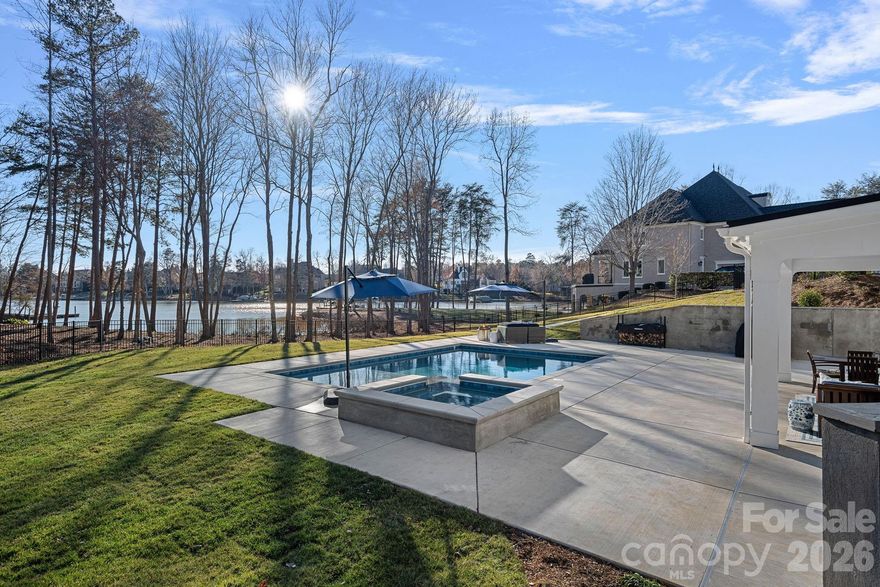 Newly built, move-in ready, and priced for today's buyer. This exceptional 2024 new construction estate in The Point delivers the full Lake Norman lifestyle without compromise Enjoy stunning water views from virtually every level, a chef's kitchen with Wolf, Sub-Zero, and dual Cove dishwashers, and craftsman moldings with custom built-ins throughout. The main-level primary suite offers peaceful water views and a custom walk-in closet. Upstairs, three spacious bedrooms surround an open loft with custom built-ins which is equally suited as a refined workspace or quiet reading retreat; plus a versatile flex room and private guest suite with en-suite bath. The fully finished lower level delivers a dedicated office with built-ins, en-suite bedroom, expansive family room, exercise space, and a laundry room with built-ins and chutes from both upper floors. Abundant walk-in storage throughout. Outside, a saltwater pool and spa overlook the lake. Boat slip Pier M #10 is just steps away with dedicated parking, plus private waterfront access for paddleboarding and kayaking. This is The Point at its finest — move in and start living it.