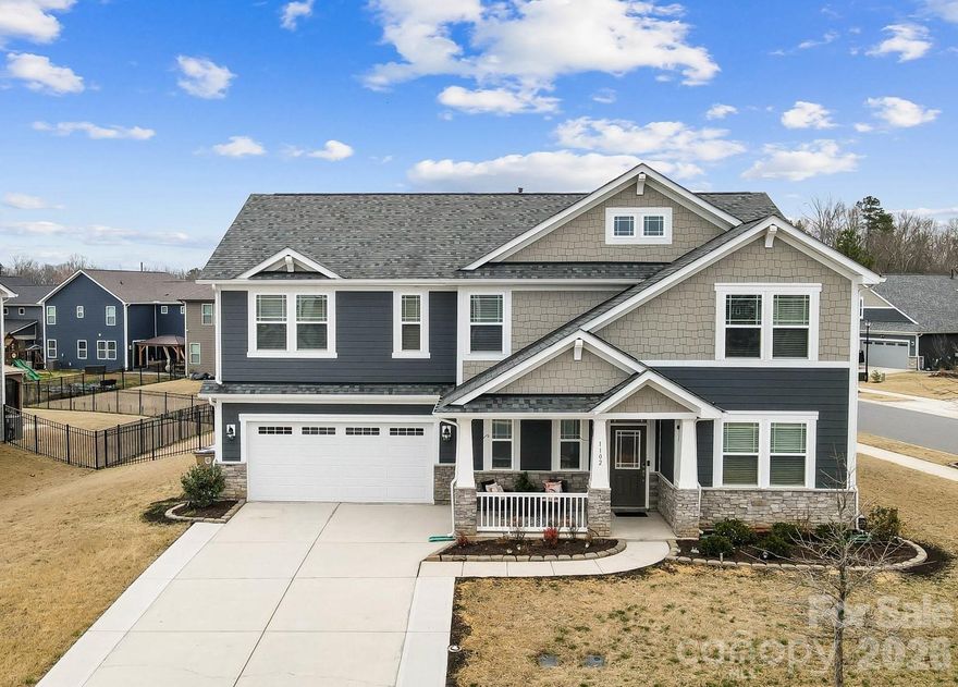 Welcome home to this move-in ready craftsman style 2-story with 5 bedrooms and 3.5 baths! This home features an in-law suite on the main level making it the perfect home for multigenerational living! Step inside from the covered rocking chair porch to the foyer where you will find a formal dining room, a spacious great room with fireplace that opens to the breakfast area and the well equipped kitchen with a large island that has pendant lighting and barstool seating, granite countertops, gas cooktop, ceramic tile backsplash, a walk-in pantry, and stainless steel appliances. There is an in-law suite with private bath that can be used for in-laws or an office or a guest space as needed. A convenient powder room and owner's entry drop zone off of the garage completes the main level. On the upper level you will find a spacious owners suite with 2 walk-in closets and private luxury bath, a conveniently located laundry room, a versatile loft area that can be used for a home office, a cozy TV/movie area, or a children’s playroom, 3 generous size secondary bedrooms and a full bathroom. Exterior features include a 2 car garage, rocking chair front porch and a covered rear patio that overlooks the fenced back yard. Additional features include  an extra wide stair case for comfortable, multi-user access and easier furniture moving, plenty of storage closets throughout the home and an extended driveway.  Community amenities include an  outdoor pool, playground, recreation area and walking trails! Great Union County schools and location convenient to local restaurants,shopping and Monroe Bypass!