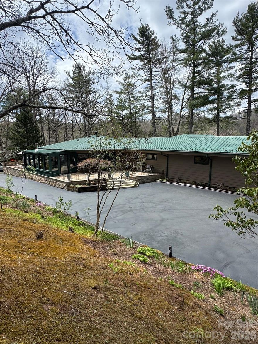 Arriving at this exceptional mid-century home inspired by Frank Lloyd Wright, you’re immediately welcomed by a paved driveway, established perennial gardens, flowering trees, lush landscaping, and intricate stonework. Step inside to discover striking tongue-and-groove Hexagon ceilings, rich hardwood floors, and an open living space that exudes warmth, centered around a beautifully crafted stone fireplace with a wraparound view. The living area flows effortlessly into a sunroom that opens onto a charming stone patio great for enjoying quiet mornings with coffee or relaxing evenings with friends. The main home offers four bedrooms and two baths (1 bedroom does not have a closet), while an attached extension provides a separate studio apartment, great for guest accommodations or dual living quarters. Numerous updates enhance the home’s appeal, including a new well pump, freshly sealed and coated driveway, on-demand water heater, new metal roof, fresh interior and exterior paint and much more! Outdoor features such as fire pits, established blueberry and raspberry bushes, garden area add even more value and charm. Enjoy the Insulated and heated 2 Car garage with storage racks and shelfing that would also make a great workspace. A detailed list of upgrades and features is available, showcasing the many thoughtful improvements throughout, far too many to mention here. Don’t miss the opportunity to experience this beautiful and versatile property.
