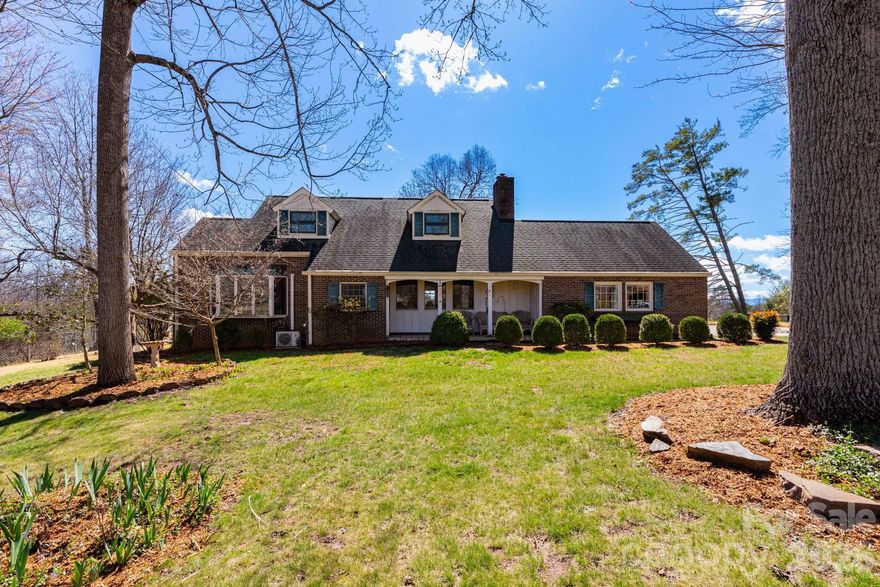 Set on a beautifully maintained and rare level .65-acre lot in the heart of Mars Hill, this lovingly cared-for brick home offers a stunning outdoor setting that truly sets it apart. Surrounded by mature landscaping and long-range mountain views, the property invites you to relax, play, and entertain with ease—all from the privacy of a quiet dead-end street with no through traffic.

The crown jewel of the home is the expansive, all-season sunroom, perfectly positioned facing southwest to capture panoramic mountain vistas and unforgettable sunsets year-round. Whether enjoying a quiet morning coffee or hosting friends in the evening glow, this light-filled space seamlessly connects indoor comfort with the beauty of the outdoors. Additional outdoor living areas include a covered front porch, spacious back deck, and a private side patio complete with a high-quality hot tub—each offering its own vantage point to take in the scenery.

Inside, the home has been meticulously maintained by the same family for over 26 years and offers a warm, inviting layout ready for your personal touches. The updated eat-in kitchen features stainless steel appliances and flows into a dedicated dining room, while the cozy living room is anchored by a classic stone wood-burning fireplace.

The flexible floor plan includes a main-level bedroom with two full baths, plus two additional bedrooms and a full bath upstairs. A two-car garage on the main level and a generous 1,200 sq ft unfinished basement with workshop space provide ample storage and exciting potential for future expansion.

Located just under a mile from Mars Hill University, as well as local shops and dining, and a short drive to Weaverville and Asheville, this home offers the perfect balance of peaceful mountain living and everyday convenience.

Come experience the beauty, views, and lifestyle this special property offers—schedule your private showing today or reach out to learn more!