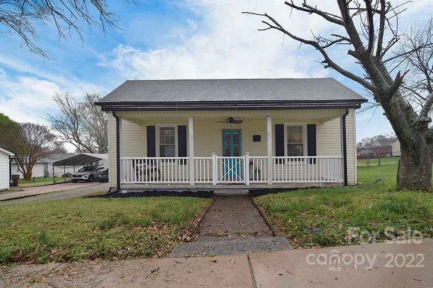 Charming country cottage, located in the Mill Village of Kannapolis! Covered, rocking chair front porch with celling fan, open concept living/dining, gorgeous hardwood floors throughout main living area and built-ins in the living room, newly renovated, white farmhouse kitchen with shiplap walls, open wood shelving, butcher block counters, stainless steel appliances, exposed brick and eat-in center island, 2 bedrooms with shared bathroom in hall, laundry room, large flat yard with freshly painted back deck, gravel pit for bonfires, and storage shed. Walking distance to the up and coming downtown Kannapolis shops, restaurants and new ball field. This is a must see!