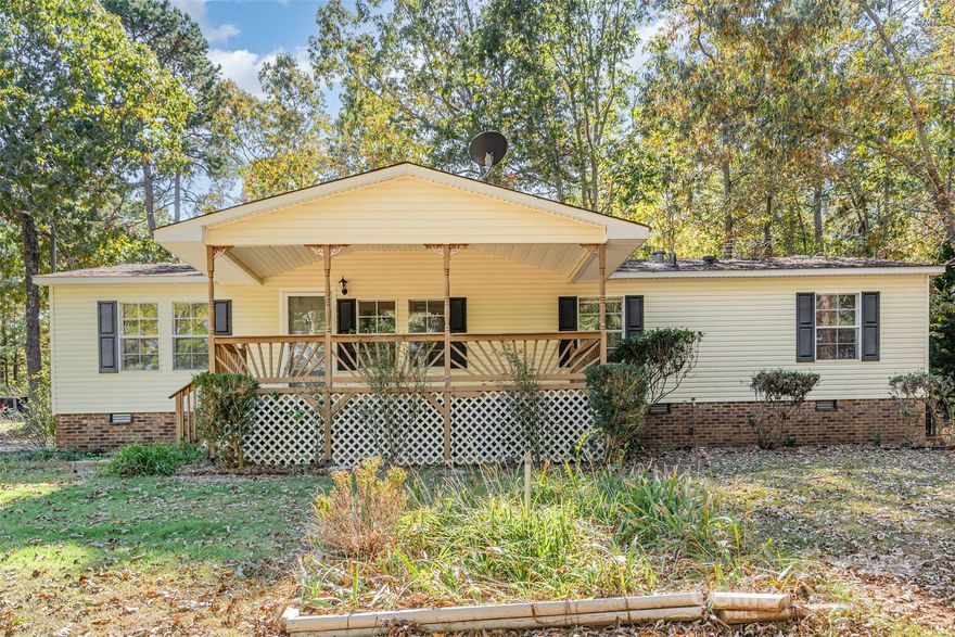 Welcome to this inviting 3-bedroom, 2-bath ranch tucked among mature trees in a quiet, established neighborhood. Set back from the road for added privacy, this home sits on a beautiful lot that backs to a peaceful stream. Inside, a cozy living room with a fireplace overlooks the large back deck, creating a warm space for relaxing or entertaining. The spacious primary suite features a large bathroom with dual sinks and a walk-in shower. With its comfortable layout, natural setting, and convenient location, this home offers a wonderful retreat from the everyday!